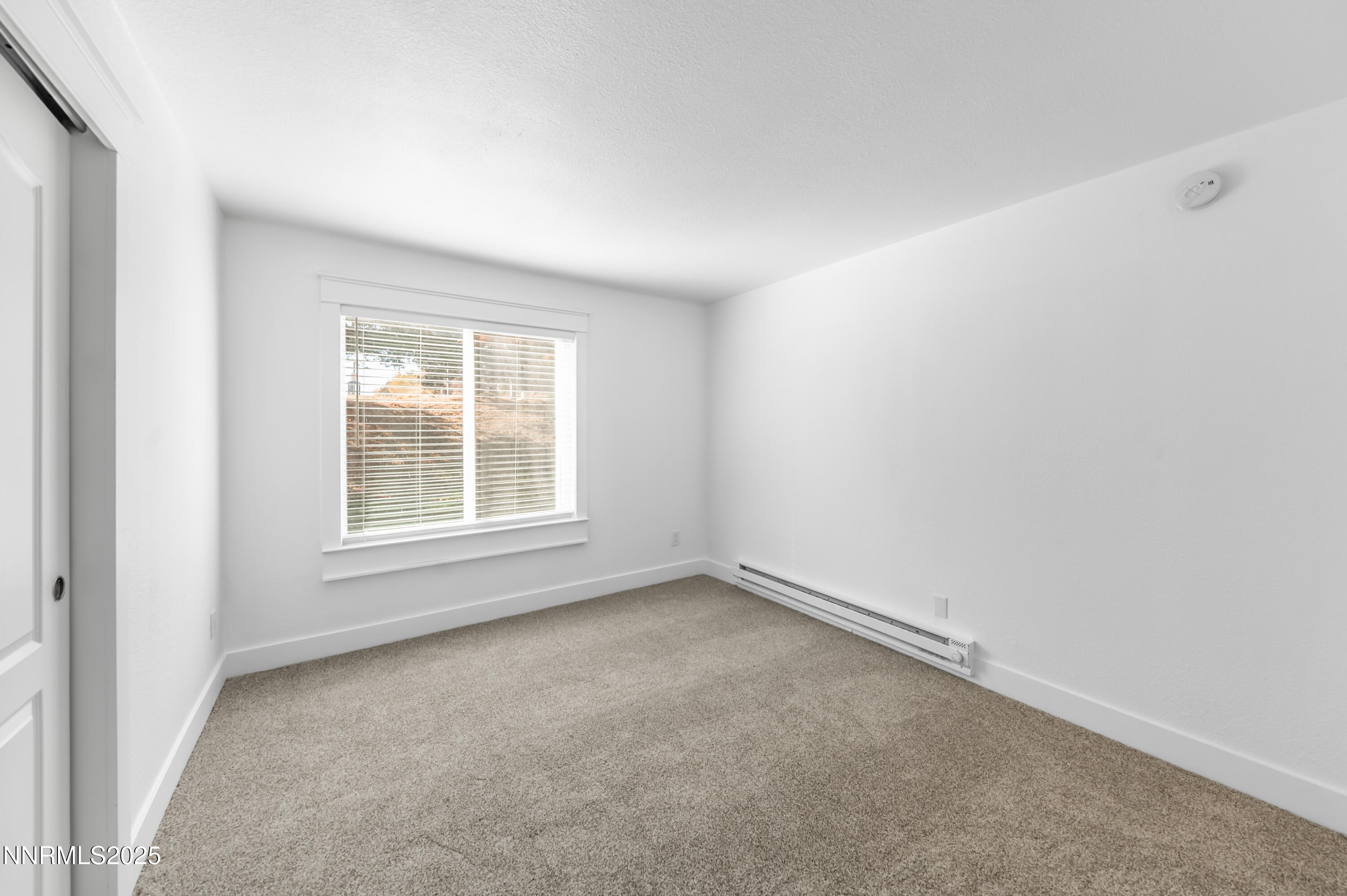 3953 Clear Acre Lane, Unit 305 Reno, NV 89512 - Photo 19 of 22 an empty room with a window