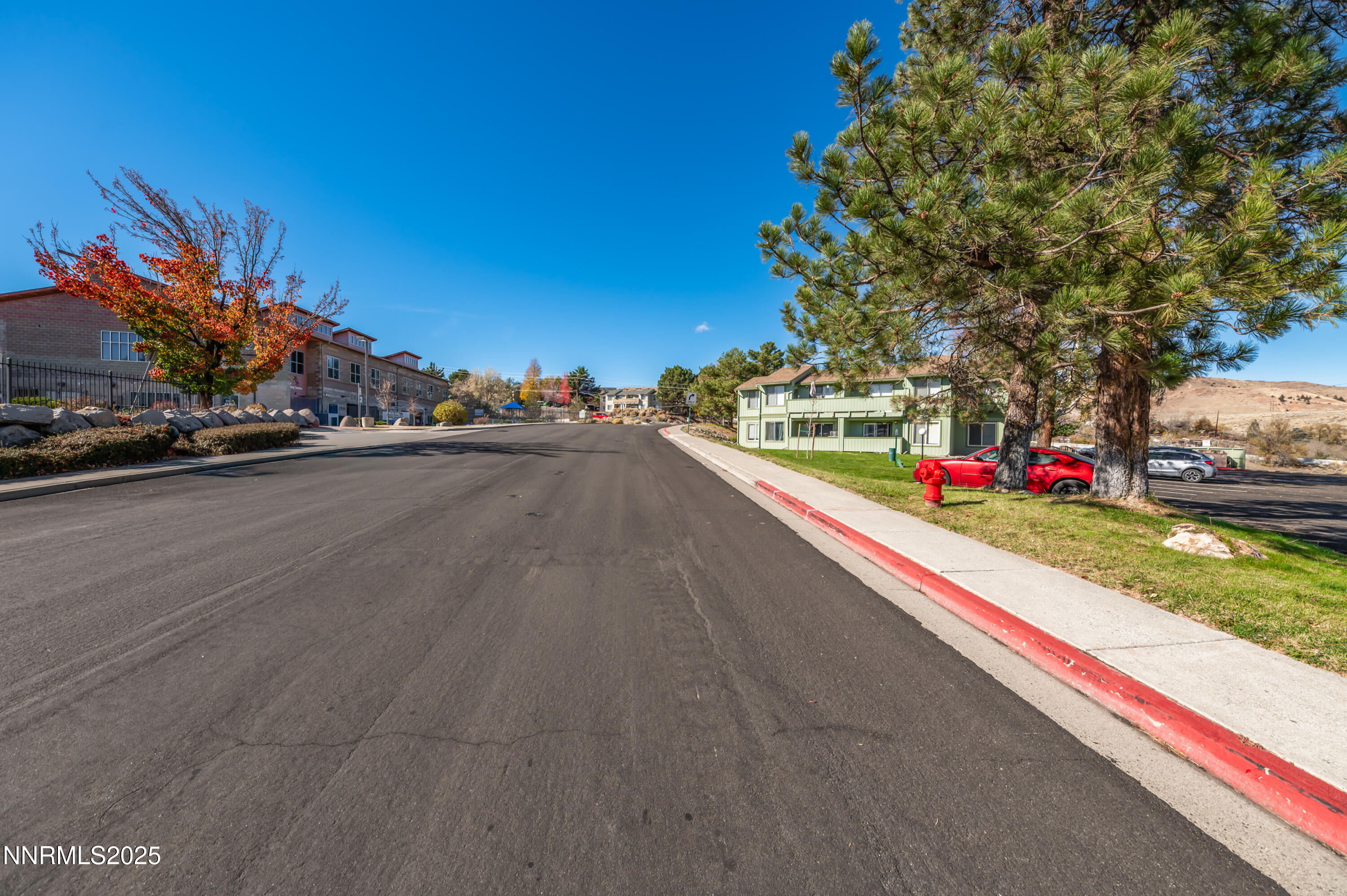 3953 Clear Acre Lane, Unit 305 Reno, NV 89512 - Photo 20 of 22 a view of a street with a cars parked on the road