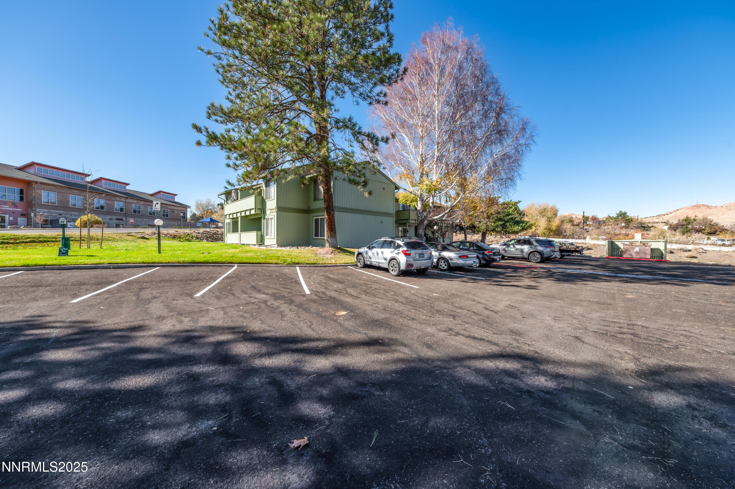 3953 Clear Acre Lane, Unit 305 Reno, NV 89512 - Photo 22 of 22 a view of a house with a big yard and large trees