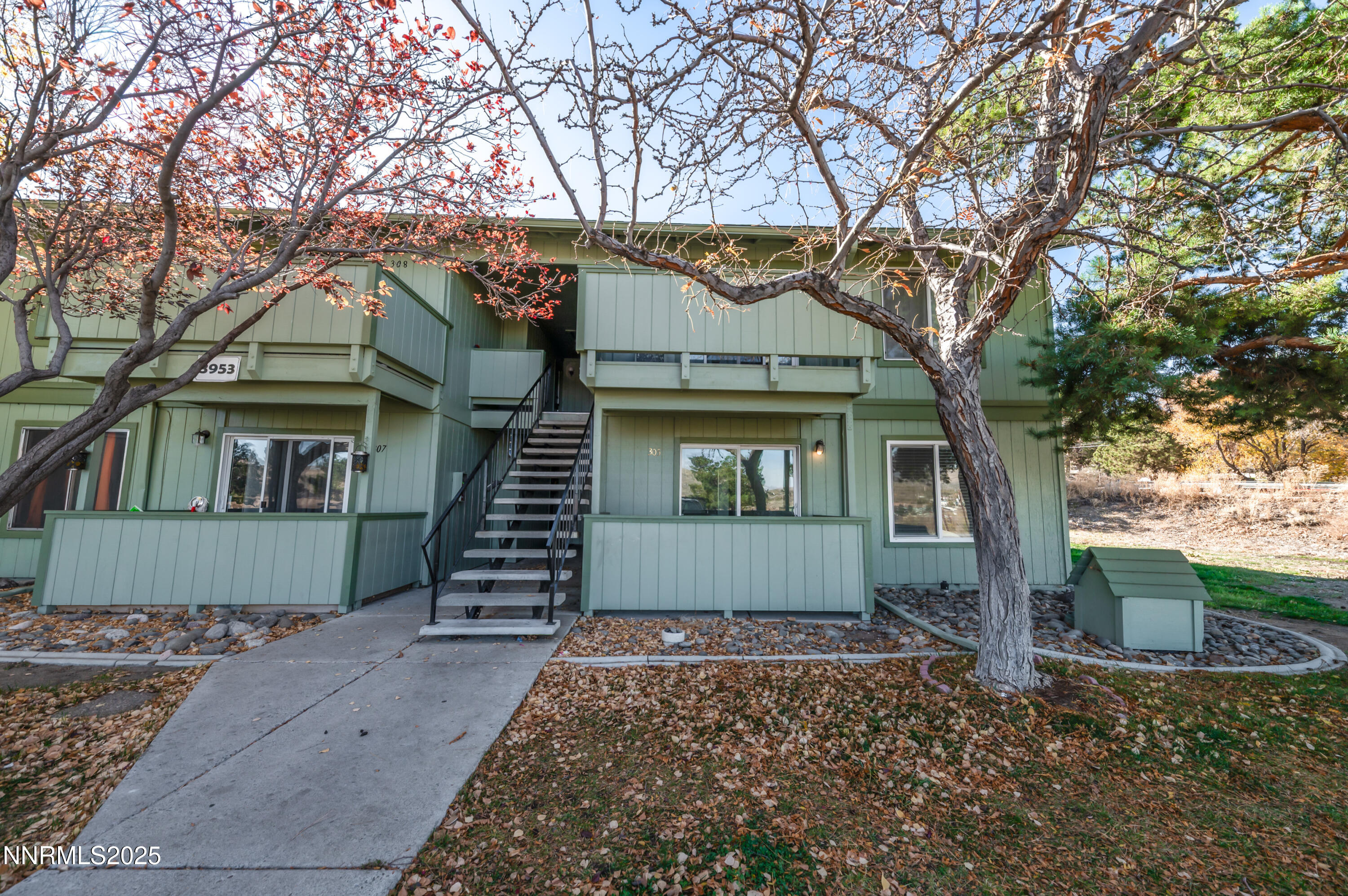 3953 Clear Acre Lane, Unit 305 Reno, NV 89512 - Photo 3 of 22 a front view of a house with a yard