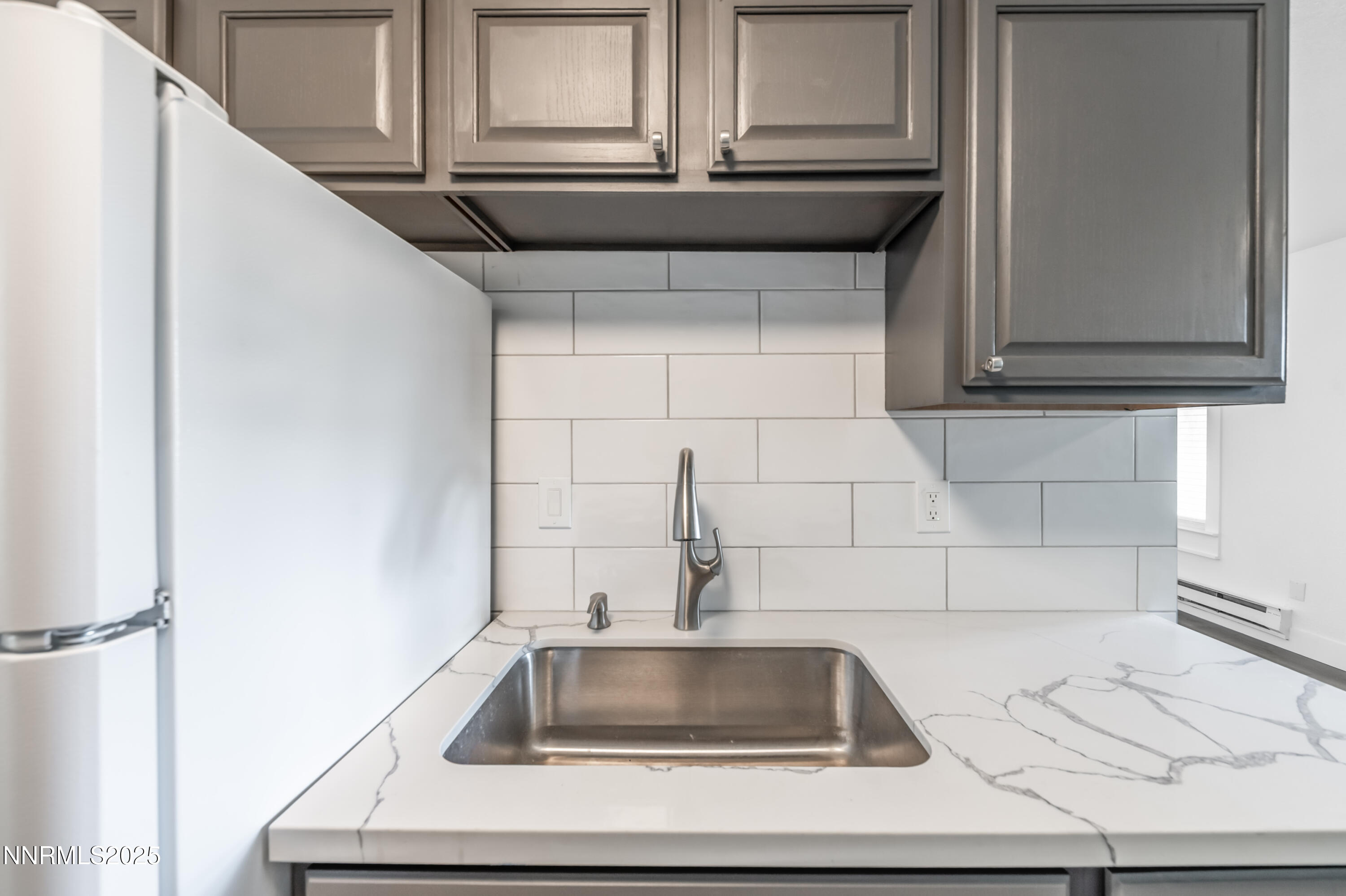 3953 Clear Acre Lane, Unit 305 Reno, NV 89512 - Photo 9 of 22 a kitchen with a sink and cabinets