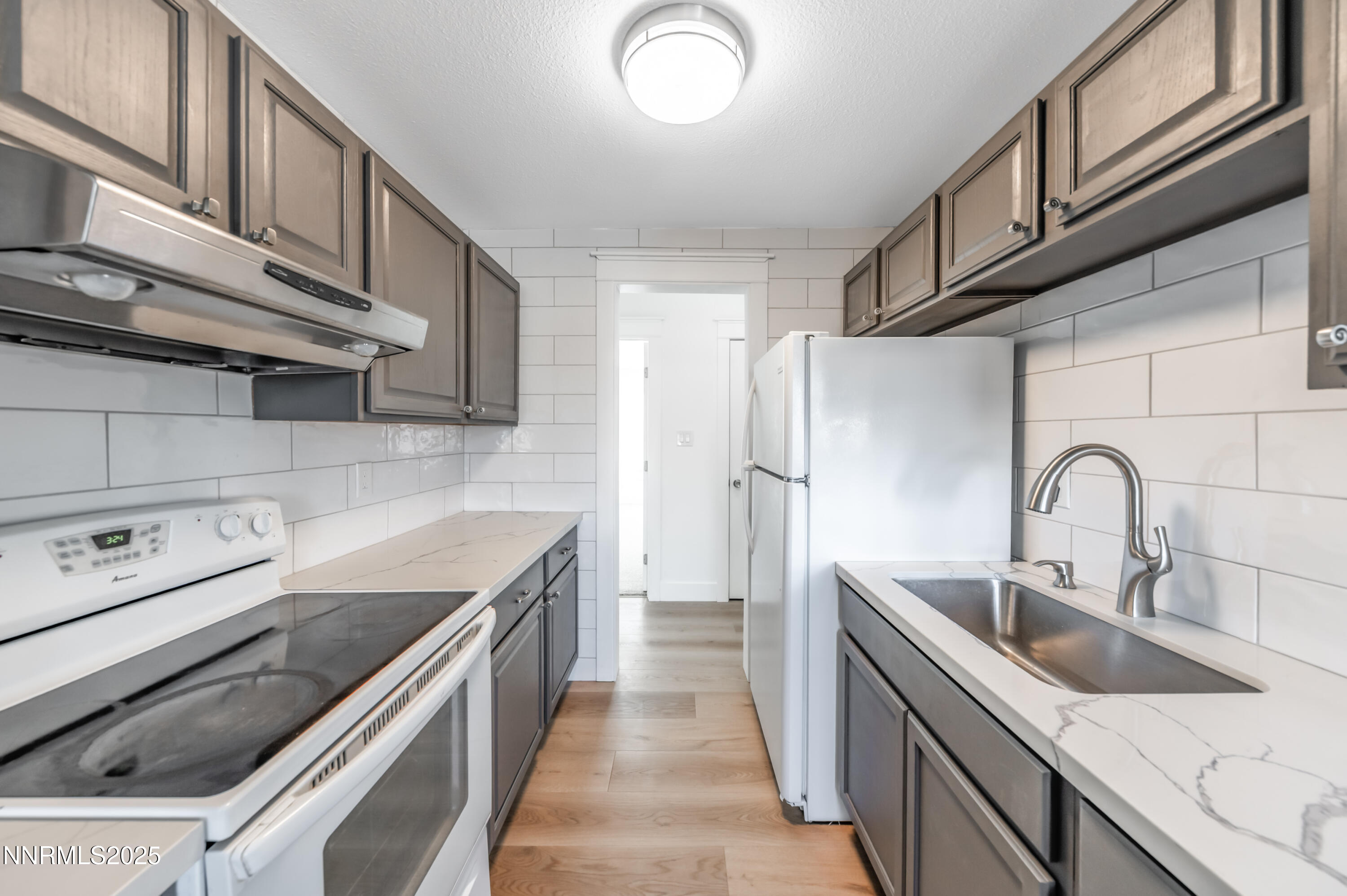 3953 Clear Acre Lane, Unit 305 Reno, NV 89512 - Photo 10 of 22 a kitchen with stainless steel appliances granite countertop a sink and a stove