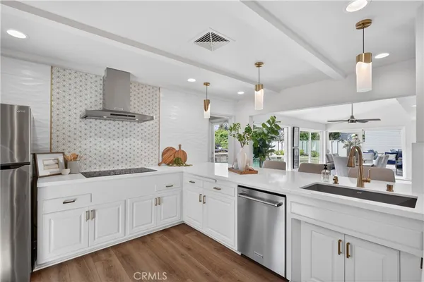a kitchen with white cabinets and sink