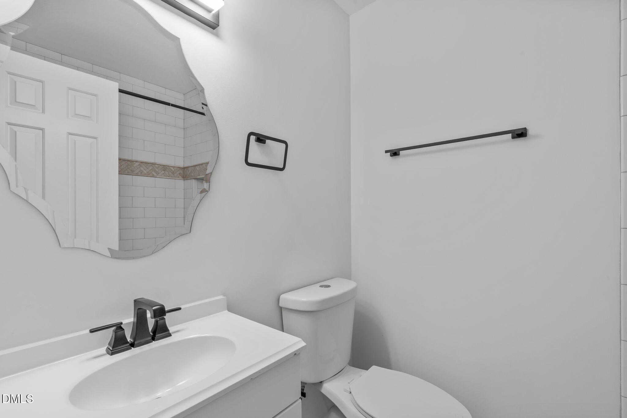 4367 Bona Court Raleigh, NC 27604 - Photo 16 of 28 a bathroom with a sink mirror and toilet