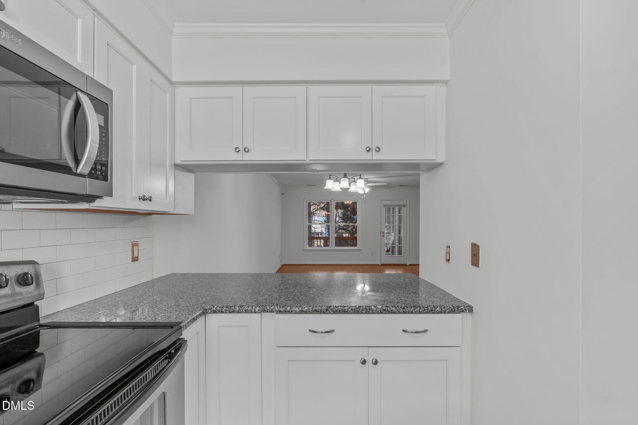 4367 Bona Court Raleigh, NC 27604 - Photo 9 of 28 a kitchen with granite countertop white cabinets and stainless steel appliances