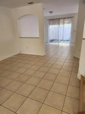 a view of an empty room and a window