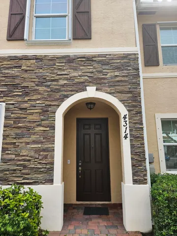 a front view of a house with stairs