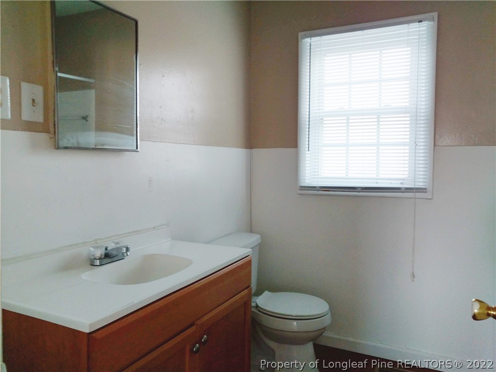 5309 Cypress Road Fayetteville, NC 28304 - Photo 11 of 15 a bathroom with a sink toilet and window
