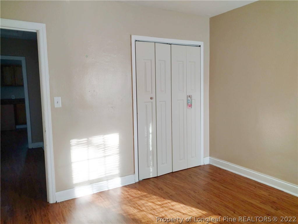 5309 Cypress Road Fayetteville, NC 28304 - Photo 12 of 15 a view of empty room with wooden floor and fan