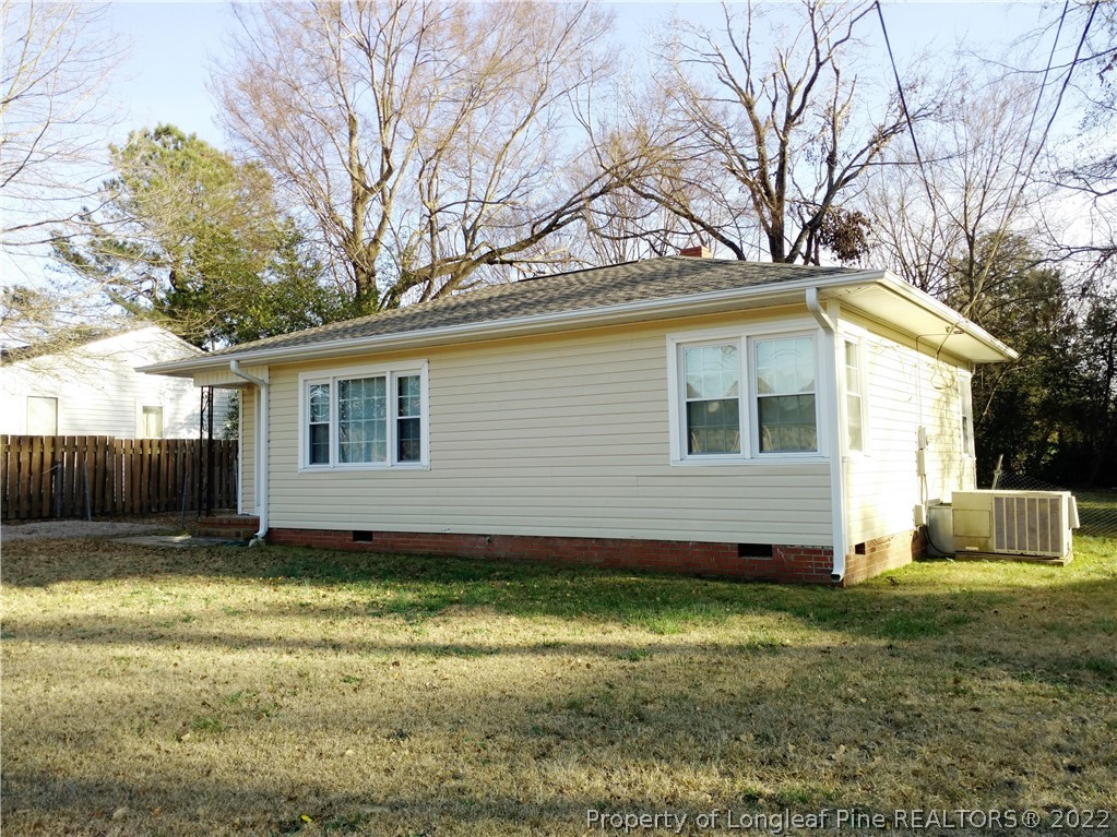 5309 Cypress Road Fayetteville, NC 28304 - Photo 2 of 15 a view of a backyard with a large tree