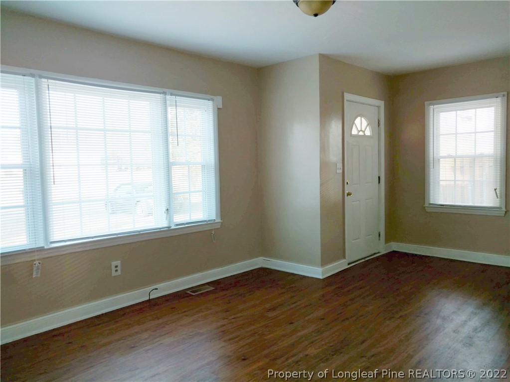5309 Cypress Road Fayetteville, NC 28304 - Photo 7 of 15 an empty room with wooden floor and windows