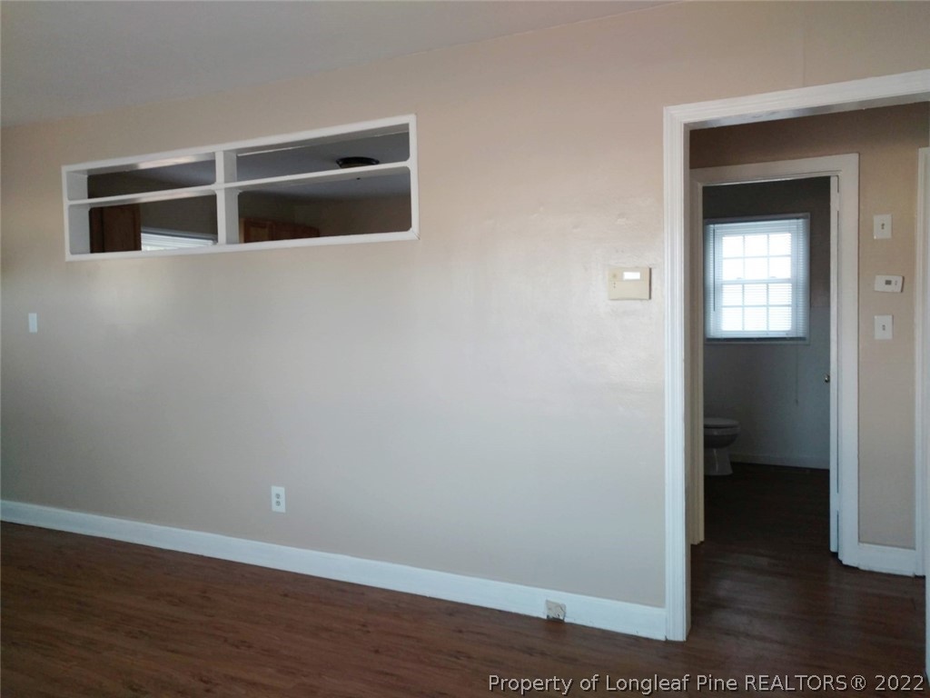 5309 Cypress Road Fayetteville, NC 28304 - Photo 8 of 15 an empty room with wooden floor closet and windows