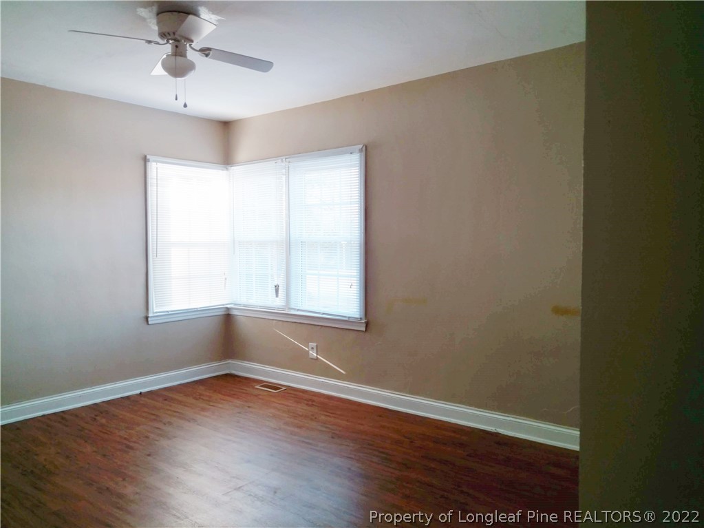 5309 Cypress Road Fayetteville, NC 28304 - Photo 10 of 15 wooden floor in an empty room with a window