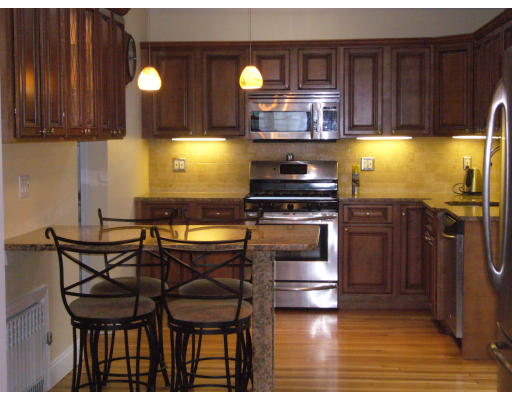 31 Waldeck Road Milton, MA 02186 - Photo 2 of 18 a kitchen with dining table chairs and wooden floor