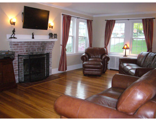 31 Waldeck Road Milton, MA 02186 - Photo 7 of 18 a living room with furniture a flat screen tv and a fireplace