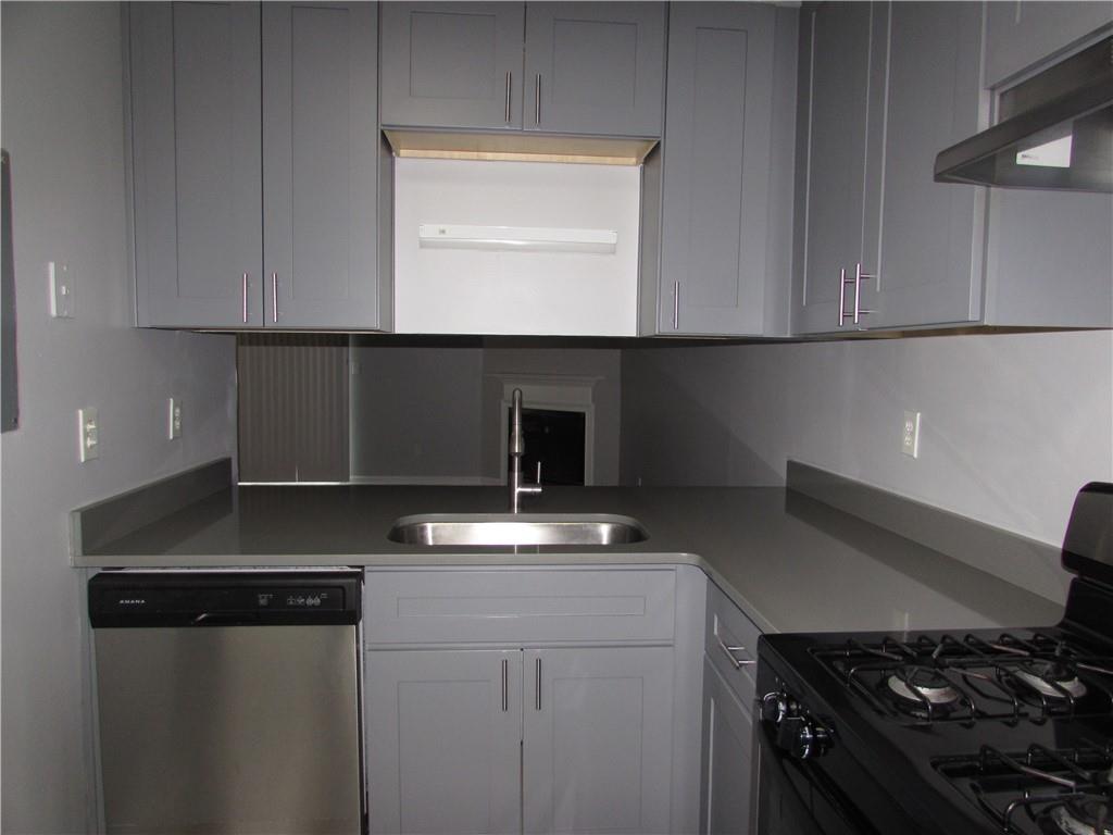 835 Heritage Valley Road Norcross, GA 30093 - Photo 8 of 34 a kitchen with cabinets and a stove top oven