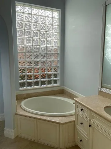 a bathroom with a bathtub and a shower