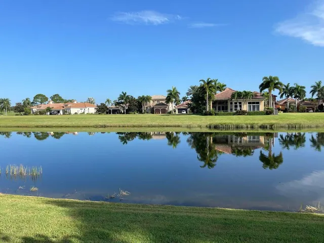 a view of a lake with houses in the background