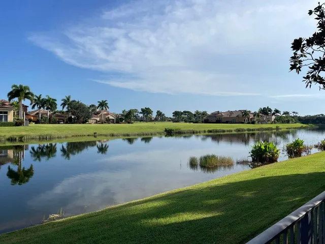 a view of a lake with houses in the background