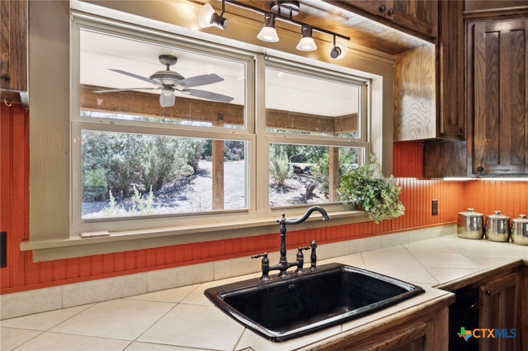 1331 Hilltop Ridge New Braunfels, TX 78132 - Photo 11 of 29 a kitchen with a sink and a window