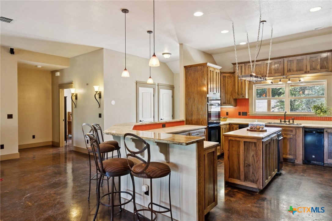 1331 Hilltop Ridge New Braunfels, TX 78132 - Photo 12 of 29 a kitchen that has a lot of cabinets in it