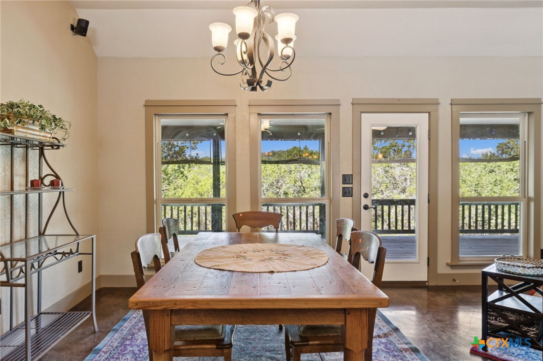 1331 Hilltop Ridge New Braunfels, TX 78132 - Photo 13 of 29 a view of a dining room with furniture window and outside view