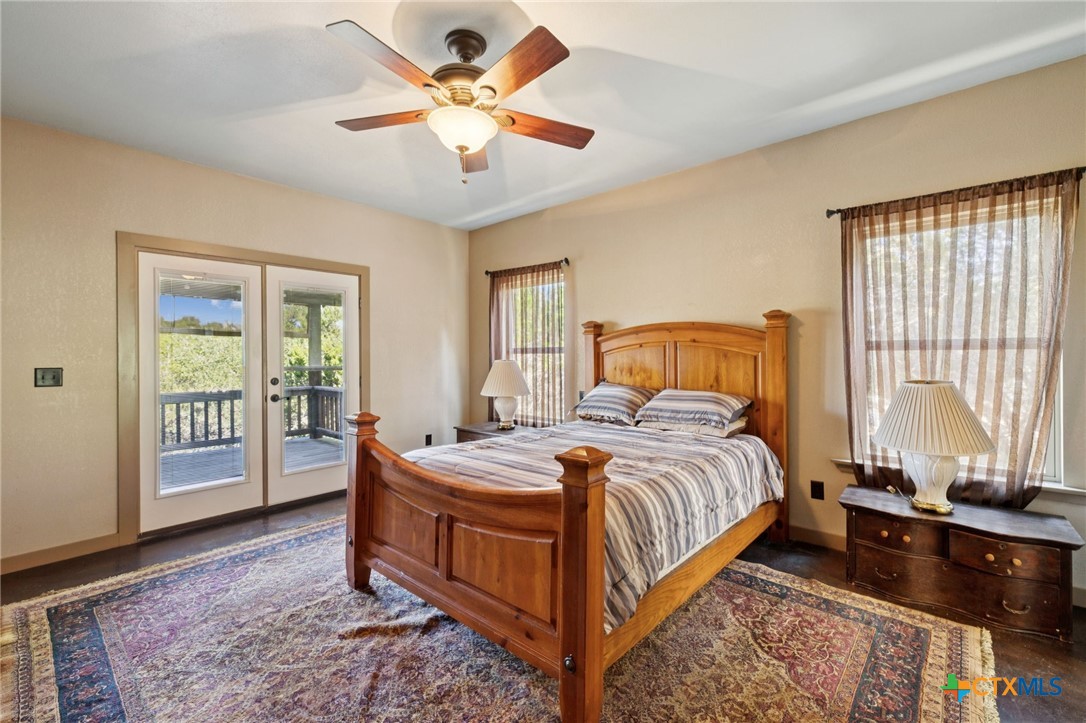 1331 Hilltop Ridge New Braunfels, TX 78132 - Photo 15 of 29 a bed room with a bed and a chandelier