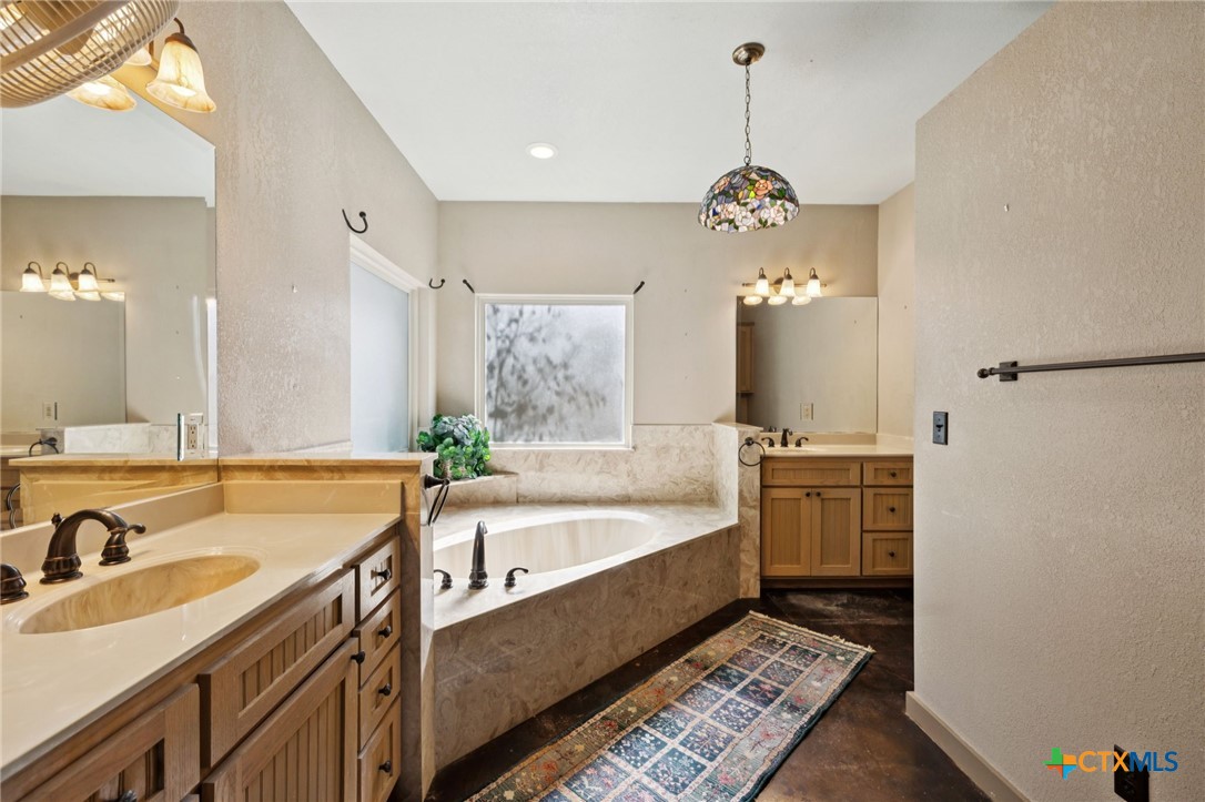 1331 Hilltop Ridge New Braunfels, TX 78132 - Photo 17 of 29 a spacious bathroom with a tub sink and mirror