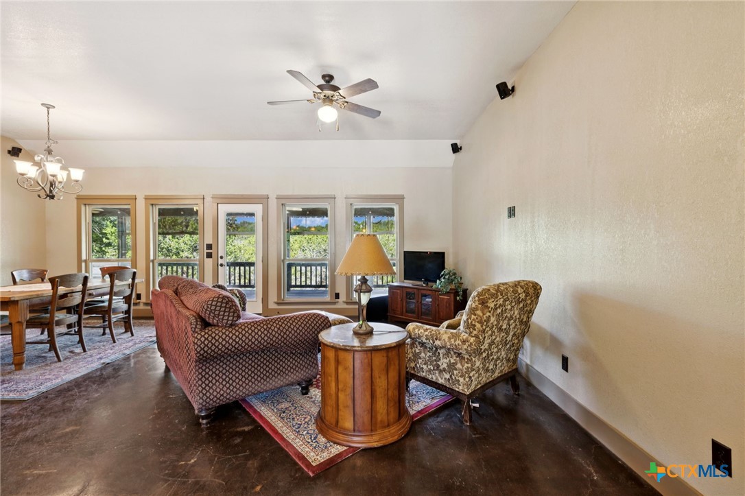 1331 Hilltop Ridge New Braunfels, TX 78132 - Photo 6 of 29 a living room with furniture a lamp and a window
