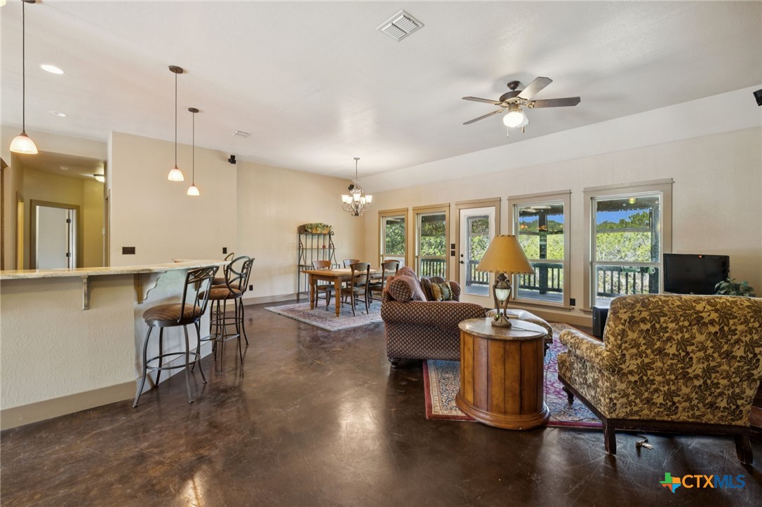 1331 Hilltop Ridge New Braunfels, TX 78132 - Photo 7 of 29 a living room with furniture and a chandelier