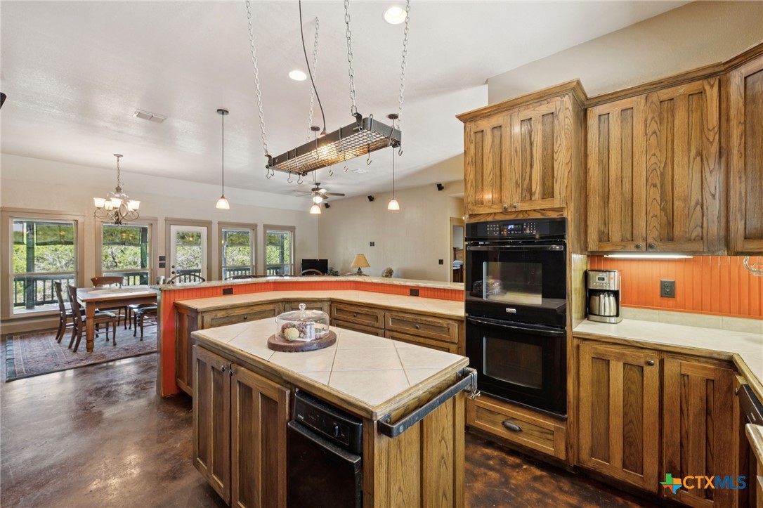 1331 Hilltop Ridge New Braunfels, TX 78132 - Photo 10 of 29 a kitchen with a stove a refrigerator a sink dishwasher with wooden cabinets and floor