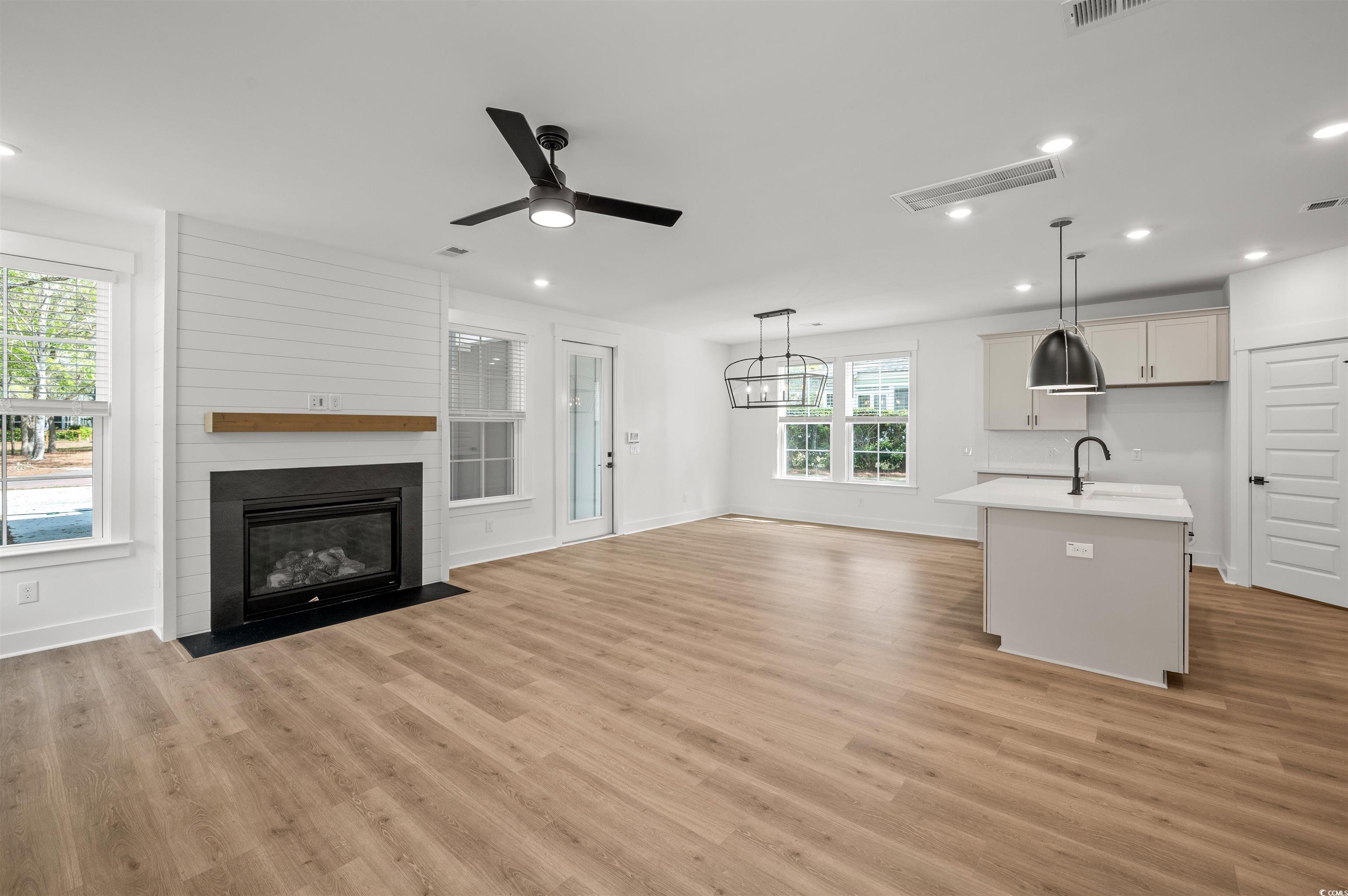 67 Bridge View Road Georgetown, SC 29440 - Photo 10 of 40 Unfurnished living room featuring recessed lighting, ceiling fan, a fireplace, and light wood-type flooring