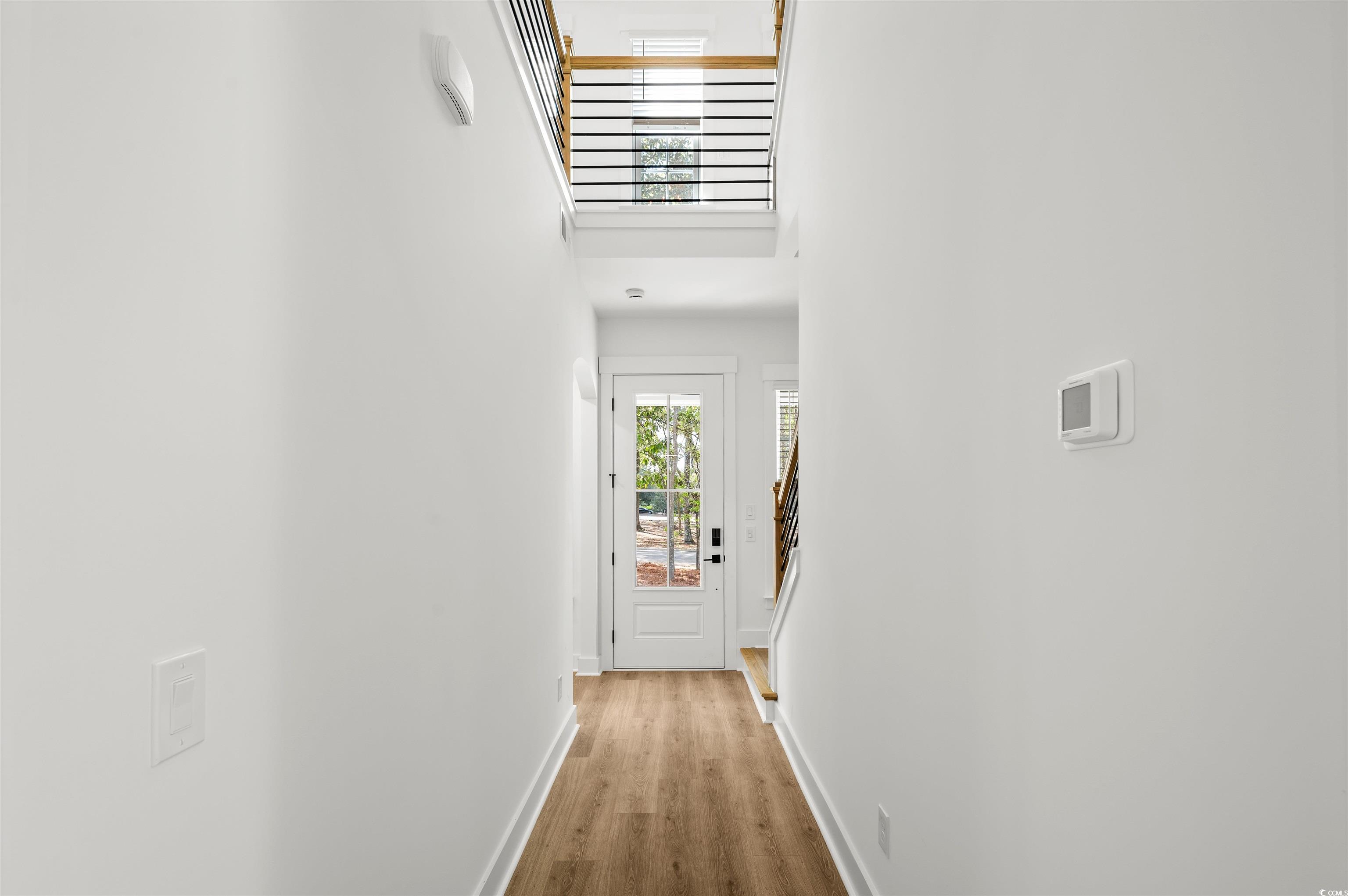 67 Bridge View Road Georgetown, SC 29440 - Photo 12 of 40 Doorway with a towering ceiling, wood finished floors, and stairway
