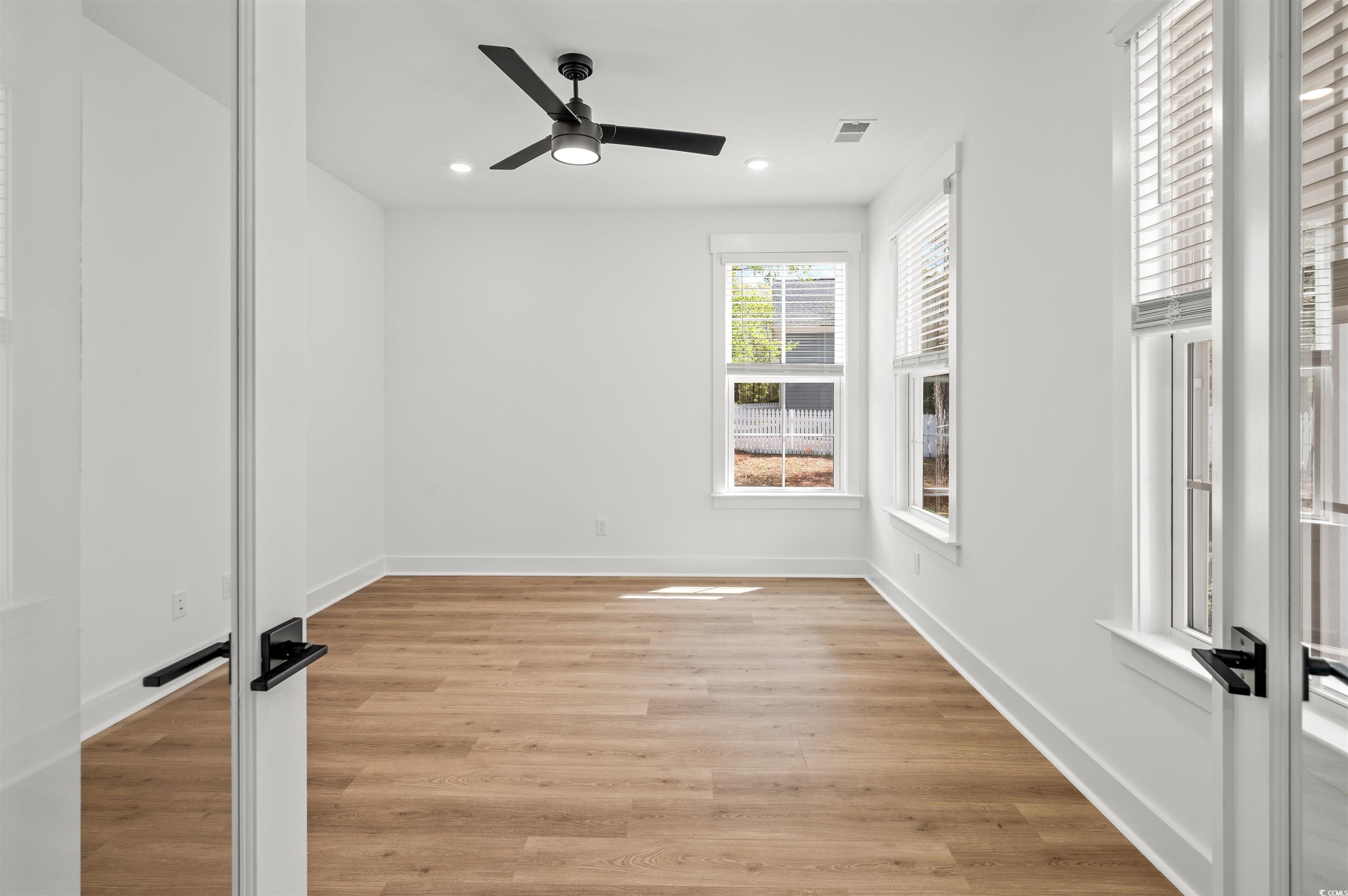 67 Bridge View Road Georgetown, SC 29440 - Photo 15 of 40 Empty room with light wood finished floors, recessed lighting, and ceiling fan