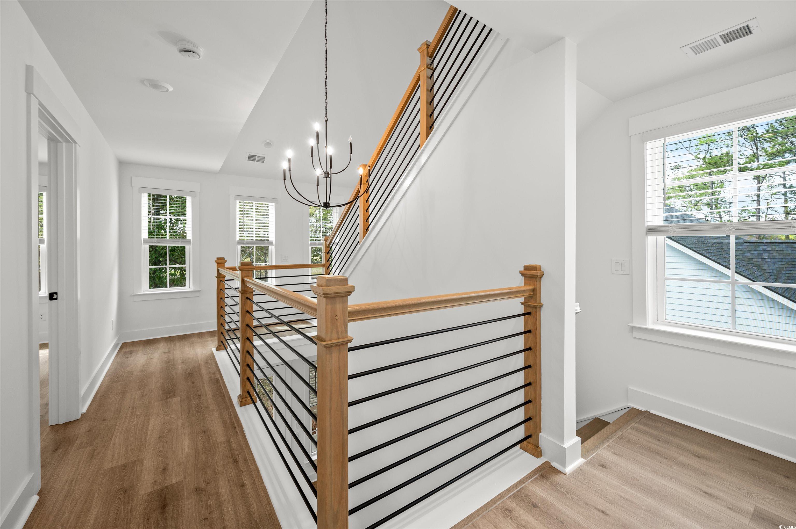 67 Bridge View Road Georgetown, SC 29440 - Photo 16 of 40 Stairs with a chandelier and wood finished floors