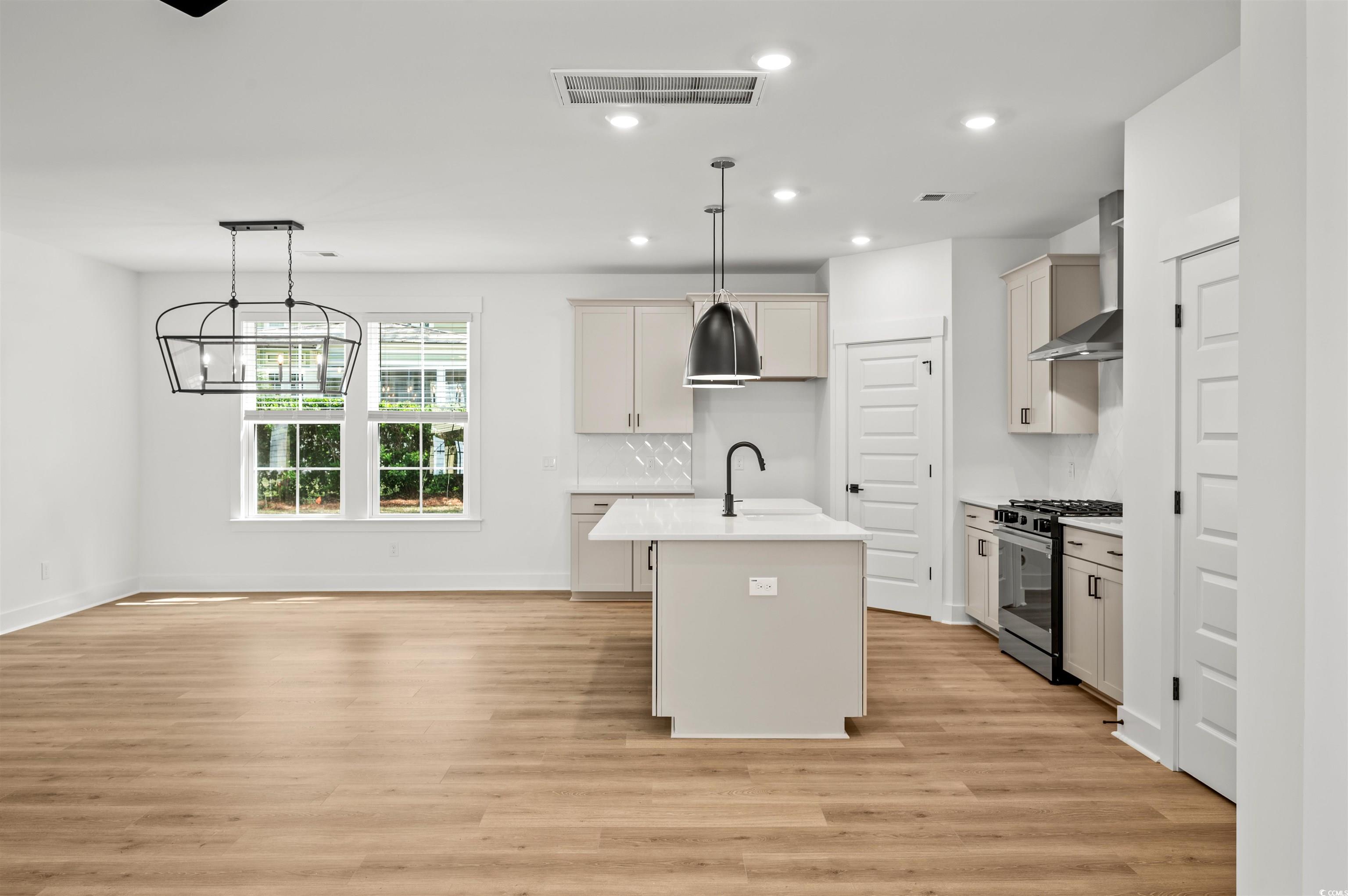 67 Bridge View Road Georgetown, SC 29440 - Photo 2 of 40 Kitchen featuring a kitchen island with sink, pendant lighting, recessed lighting, gas stove, and light wood-style floors