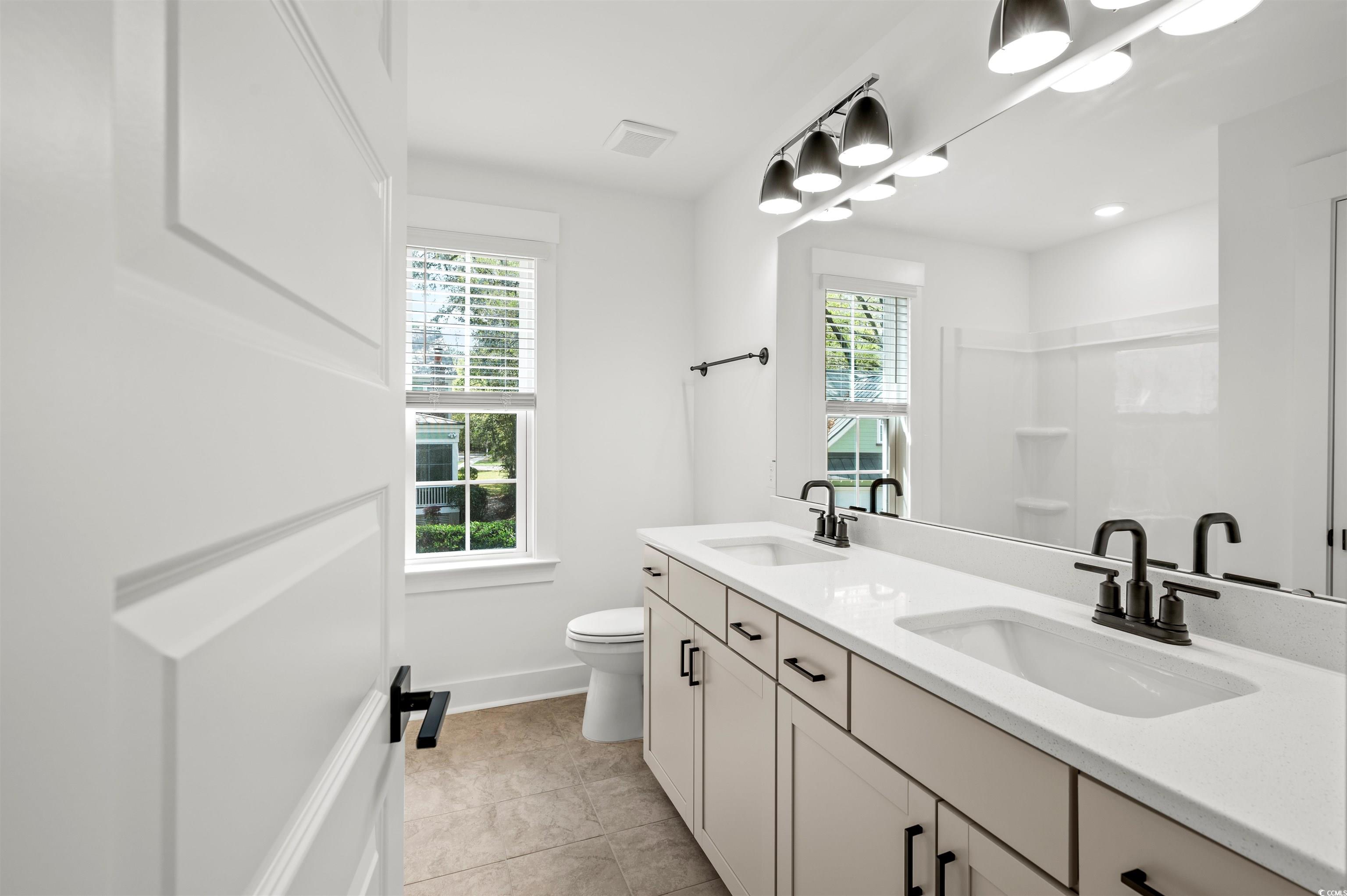 67 Bridge View Road Georgetown, SC 29440 - Photo 28 of 40 Full bathroom featuring double vanity, a shower, and light tile patterned floors