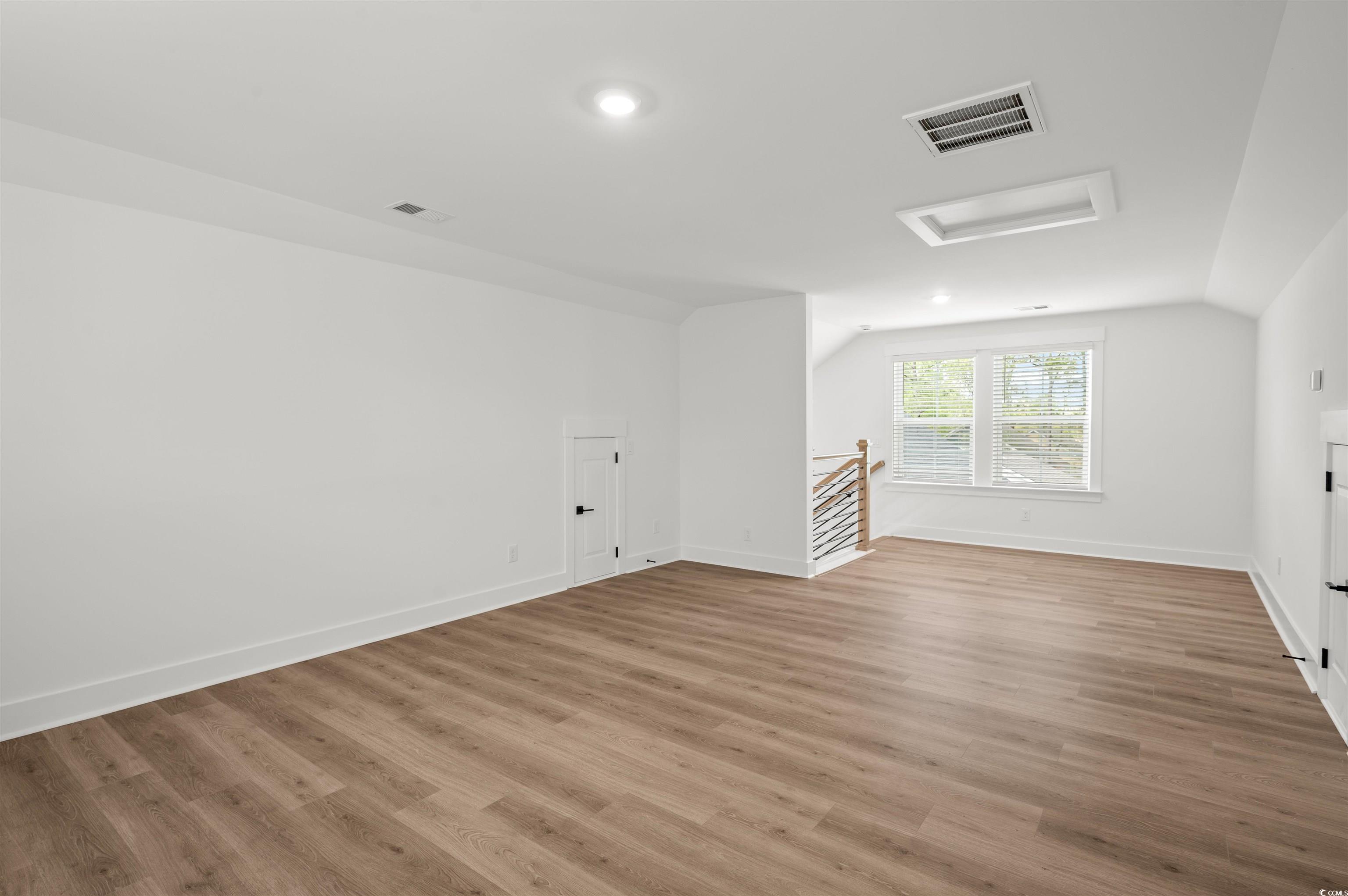 67 Bridge View Road Georgetown, SC 29440 - Photo 30 of 40 Additional living space featuring attic access, light wood-style floors, and vaulted ceiling