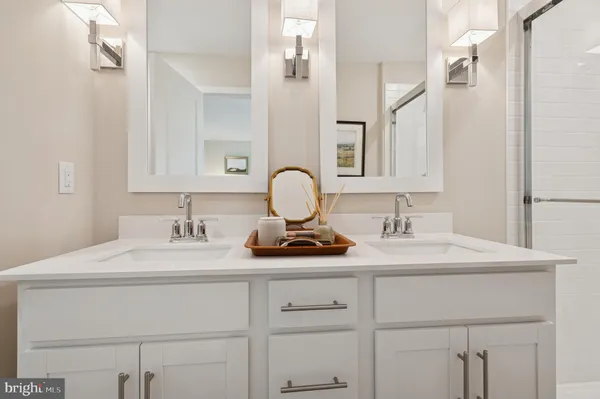 a bathroom with a sink vanity granite and a mirror