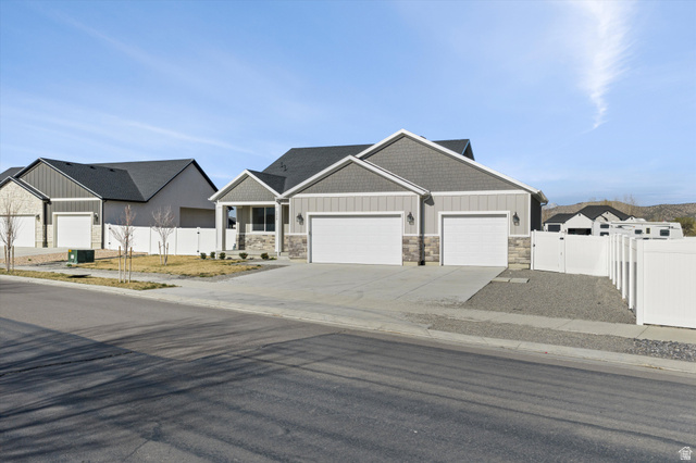 3938 North Wood Road Eagle Mountain, UT 84005 - Photo 4 of 55 Craftsman-style home with a gate, an attached garage, stone siding, driveway, and board and batten siding