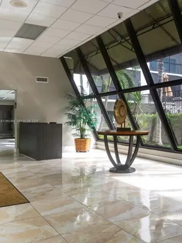 a view of a workspace with furniture and a book shelf