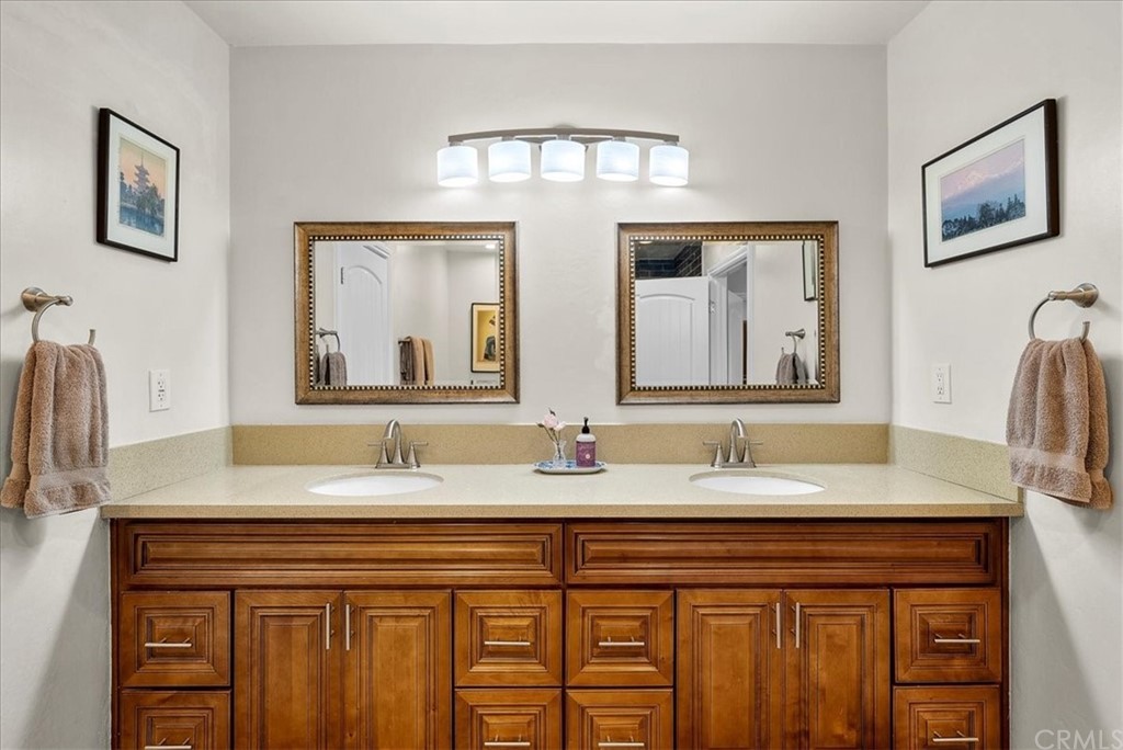 1137 Vía Coronel Palos Verdes Estates, CA 90274 - Photo 15 of 20 a bathroom with a granite countertop double vanity sink and two mirror