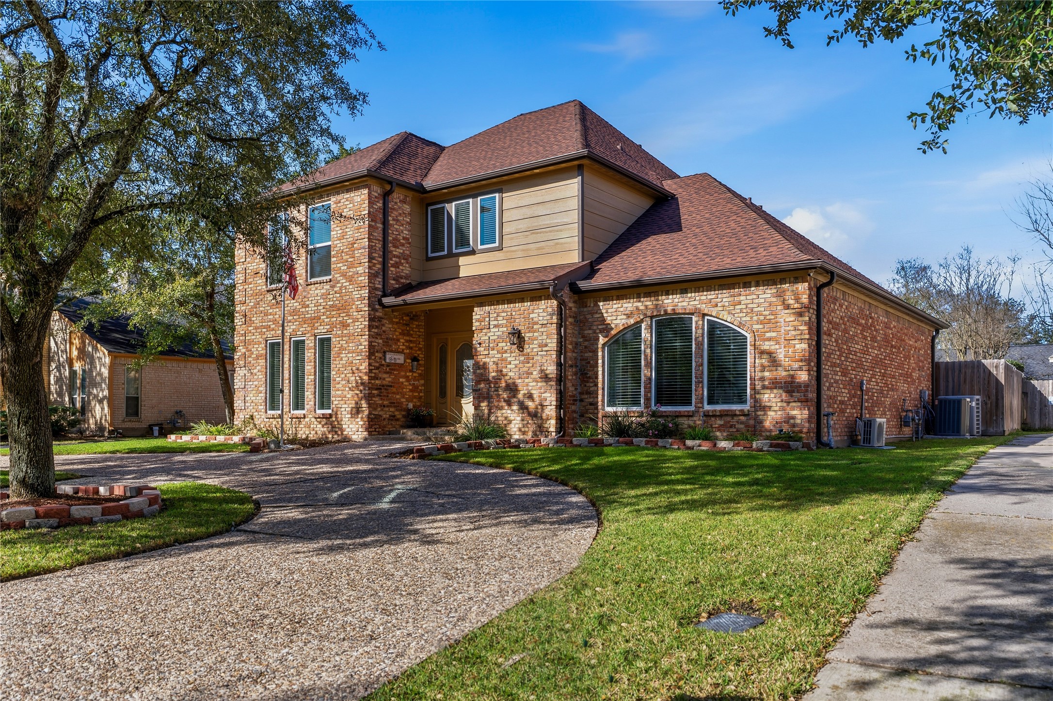Welcome Home!  This elegant two-story brick home with mature trees, manicured landscaping, and a circular driveway offers excellent curb appeal.