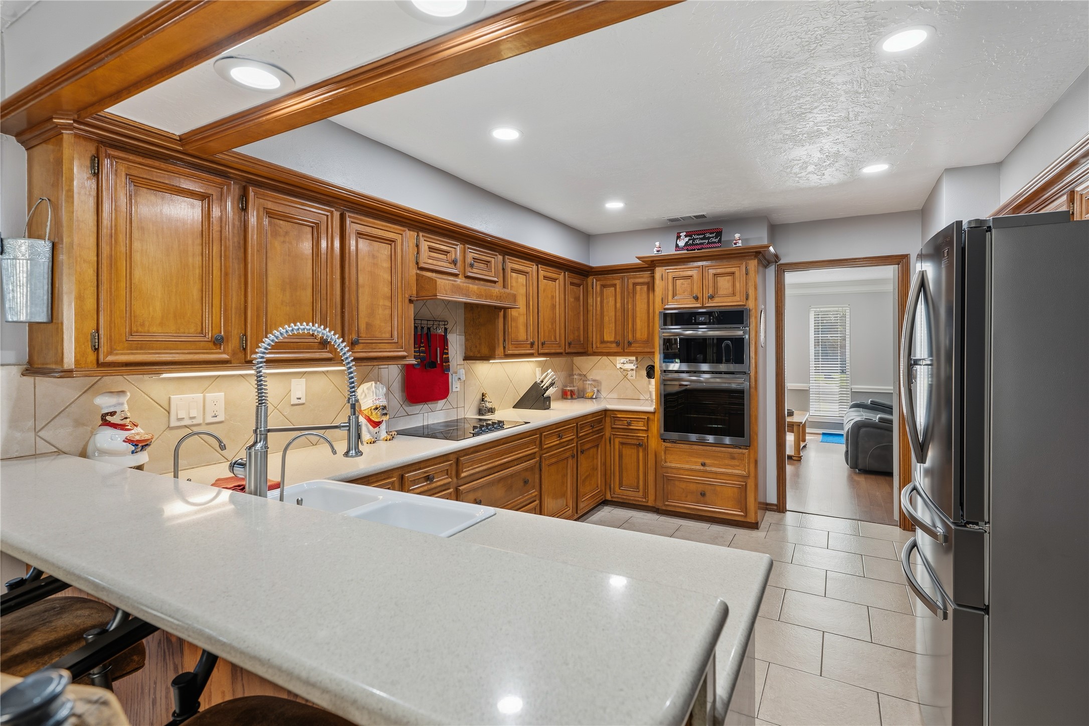 6618 Wimbledon Trail Road Spring, TX 77379 - Photo 15 of 44 a large kitchen with stainless steel appliances a large counter top a stove a refrigerator and a sink