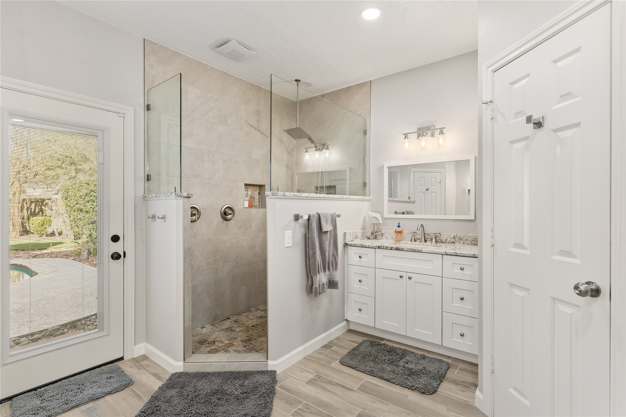 6618 Wimbledon Trail Road Spring, TX 77379 - Photo 27 of 44 a spacious bathroom with a granite countertop sink mirror and shower
