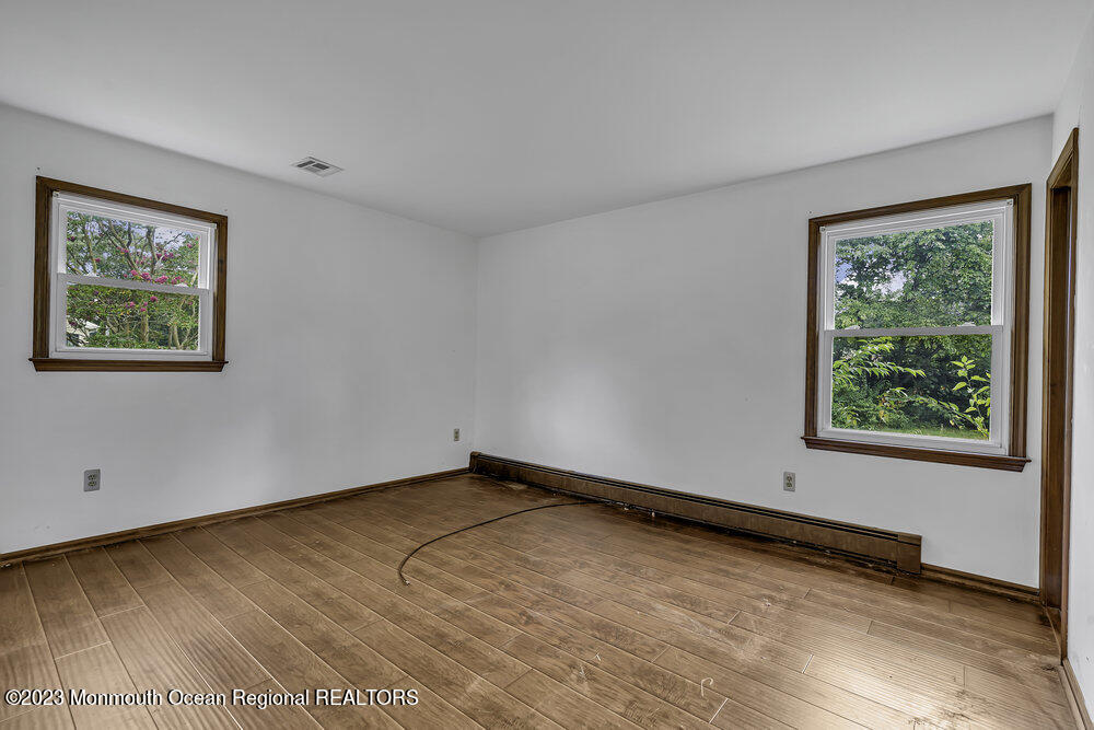 10 Eagle Drive Bayville, NJ 08721 - Photo 11 of 42 an empty room with wooden floor and windows