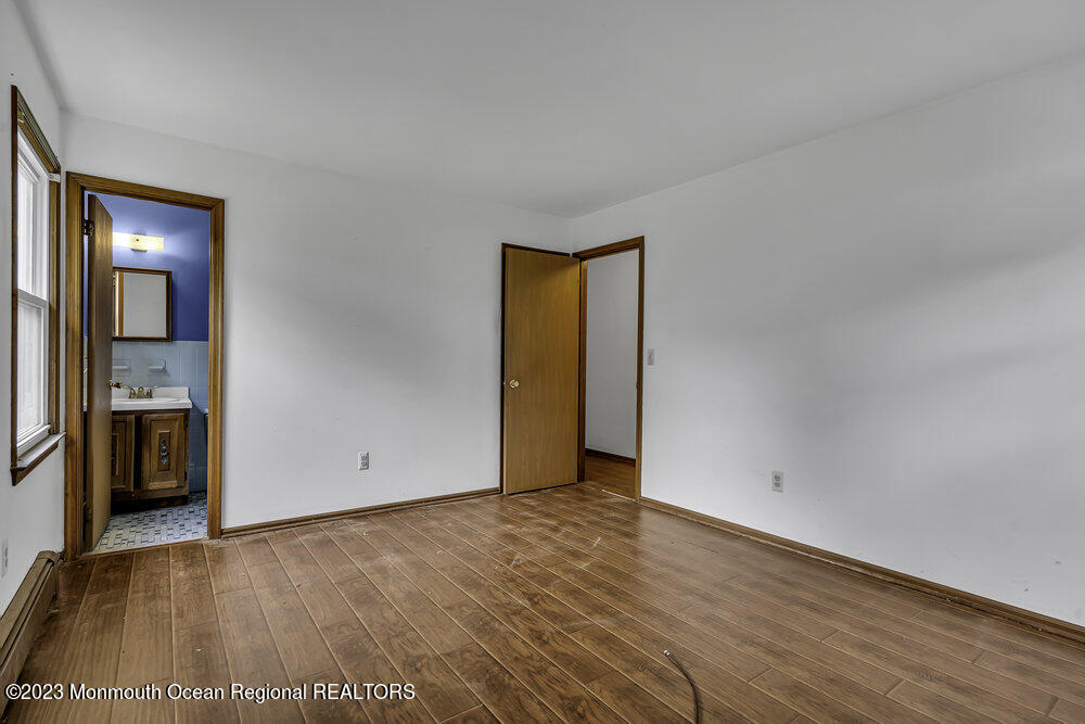 10 Eagle Drive Bayville, NJ 08721 - Photo 15 of 42 a view of an empty room with a window and wooden floor