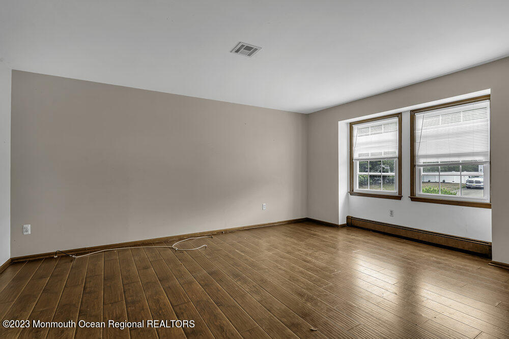 10 Eagle Drive Bayville, NJ 08721 - Photo 17 of 42 a view of an empty room with wooden floor and a window