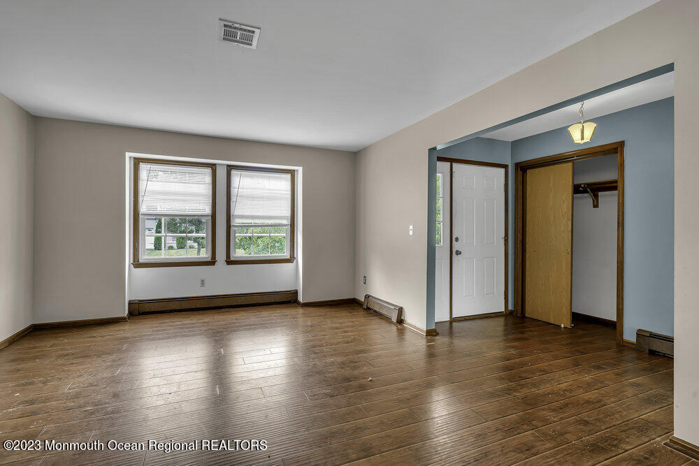 10 Eagle Drive Bayville, NJ 08721 - Photo 19 of 42 an empty room with wooden floor and windows
