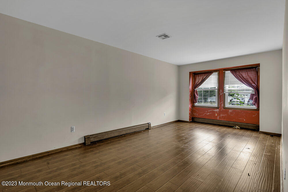10 Eagle Drive Bayville, NJ 08721 - Photo 20 of 42 an empty room with wooden floor and windows